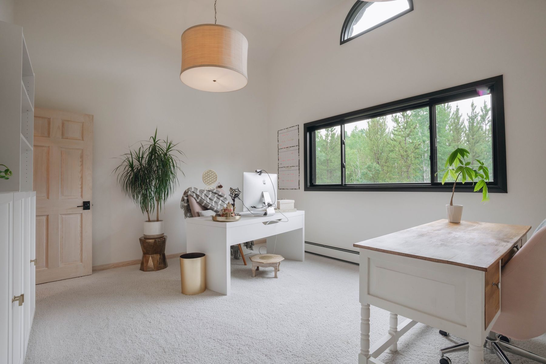 Dedicated home office with two desks and forest views